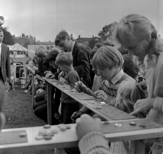 Border Counties Advertizer: Pictures for Oswestry Advertizer Memory Lane supplement Children on a stall at Oswestry Town Football Clubs fete in Cae Glas Park, Oswestry, 1/9/69.
